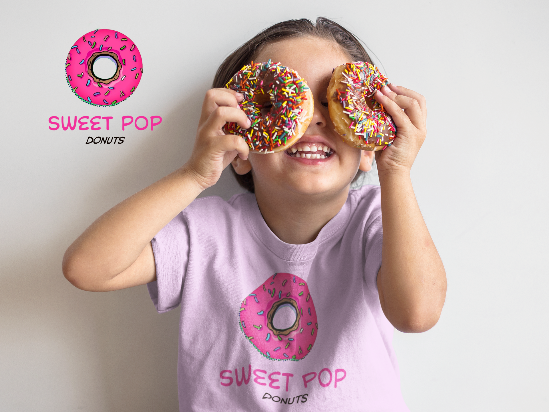 boy-playing-with-donuts-while-wearing-a-t-shirt-mockup-against-a-white-wall-a16139